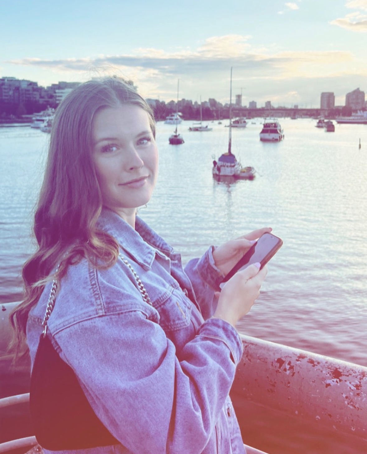 A photograph of Ainsley Kelly by the water in Downtown, Vancouver.